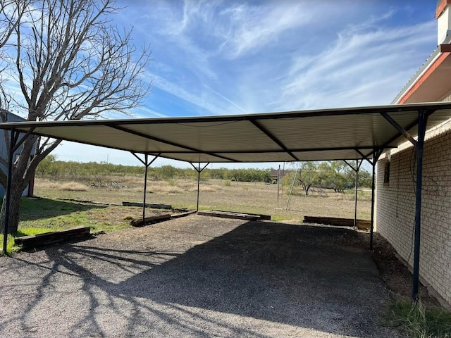 view of car parking with a rural view