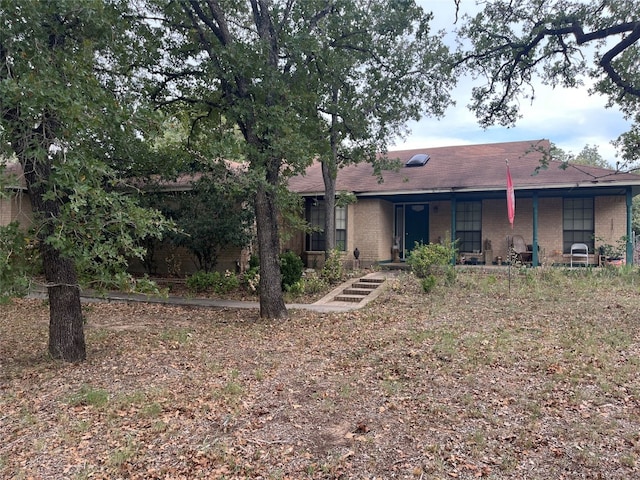 back of house featuring a porch