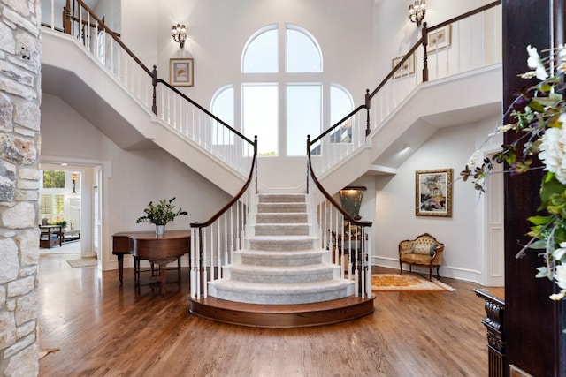 interior space with hardwood / wood-style flooring and a high ceiling