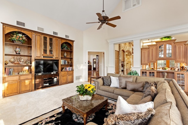 carpeted living room featuring ceiling fan and high vaulted ceiling