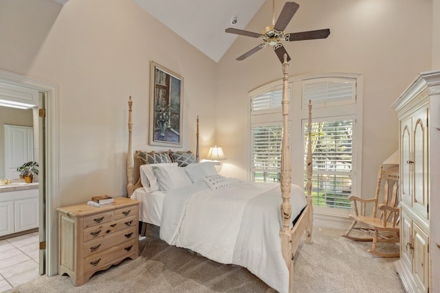 bedroom with light colored carpet, ceiling fan, high vaulted ceiling, and sink