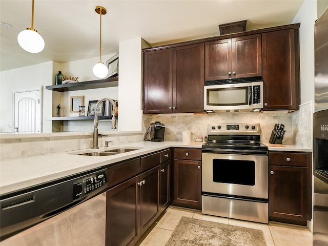 kitchen with decorative light fixtures, appliances with stainless steel finishes, dark brown cabinetry, light tile floors, and backsplash