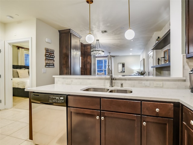 kitchen with a chandelier, pendant lighting, dishwashing machine, dark brown cabinets, and sink