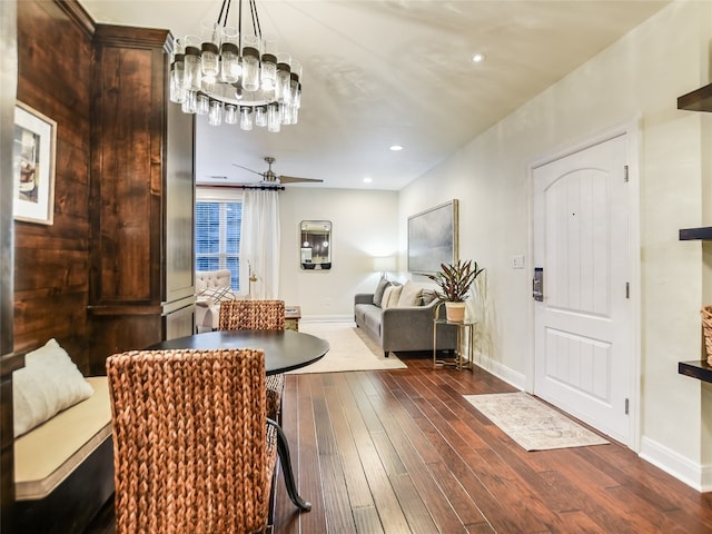 interior space featuring dark hardwood / wood-style floors and ceiling fan with notable chandelier