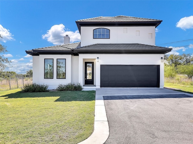 view of front of house featuring a front yard and a garage