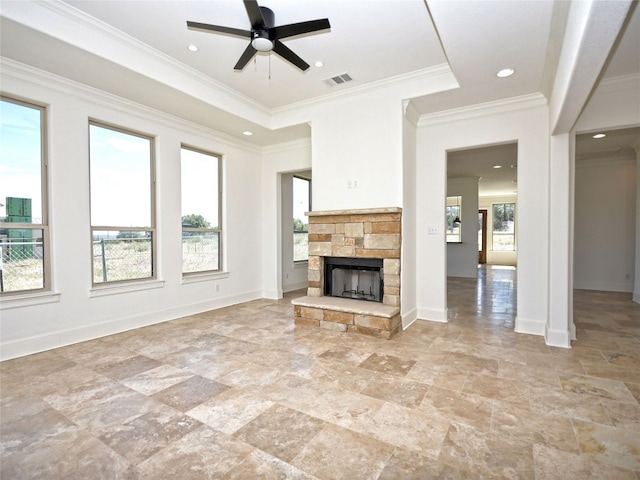 unfurnished living room featuring plenty of natural light, light tile floors, ceiling fan, and a fireplace