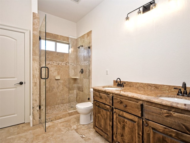 bathroom featuring tile floors, a shower with door, toilet, and dual bowl vanity