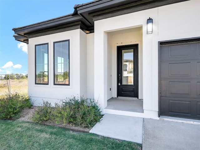 property entrance with a lawn