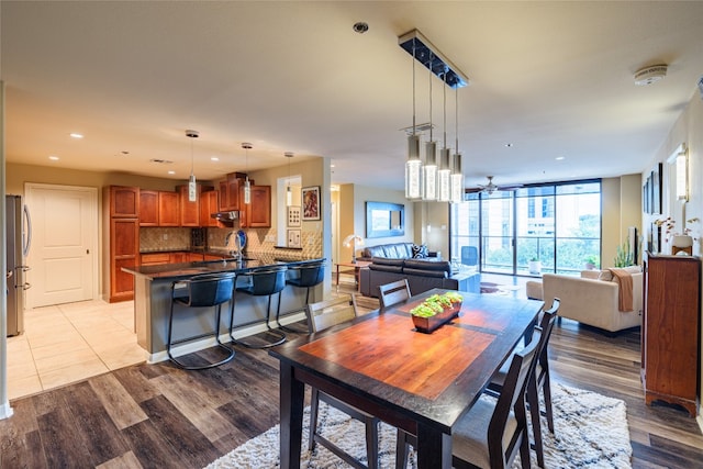 tiled dining area featuring sink and ceiling fan