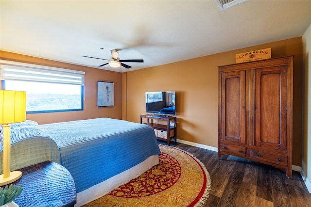 bedroom with ceiling fan and dark hardwood / wood-style flooring