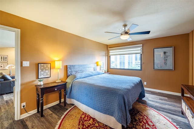 bedroom with dark hardwood / wood-style floors and ceiling fan