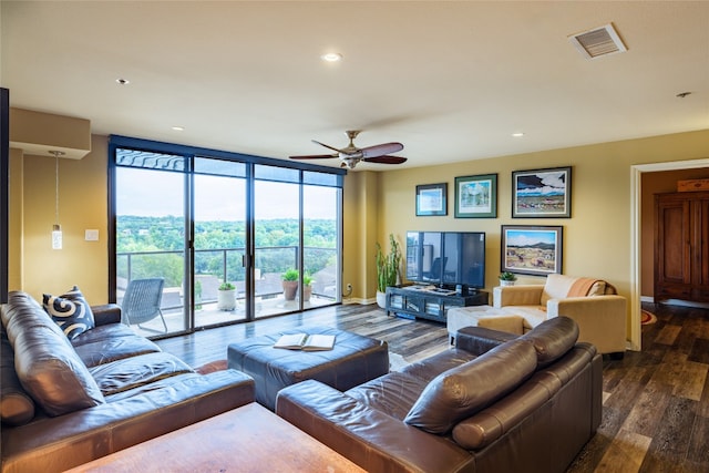 living room featuring dark wood-type flooring, expansive windows, and ceiling fan