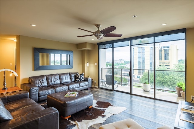 living room featuring floor to ceiling windows, wood-type flooring, and ceiling fan