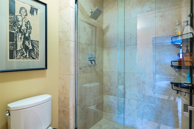 bathroom featuring an enclosed shower and toilet