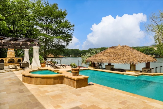 view of pool featuring an in ground hot tub, an outdoor stone fireplace, a gazebo, a patio, and a pergola