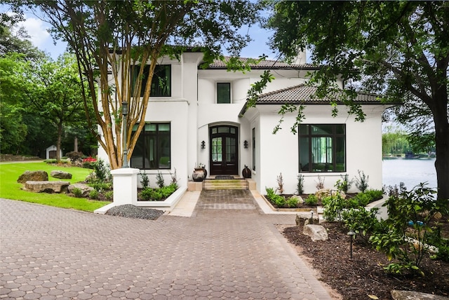 mediterranean / spanish-style home with french doors