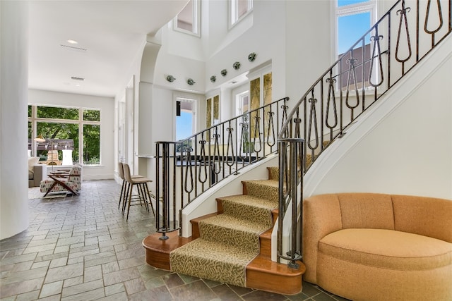 stairs featuring a high ceiling