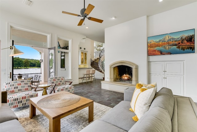 living room featuring dark tile floors and ceiling fan