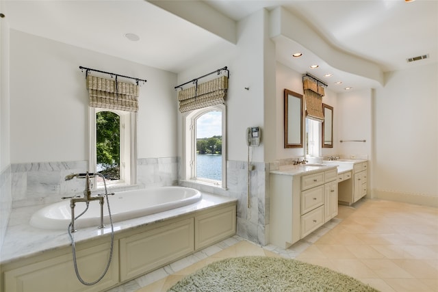 bathroom with tile floors, a bath, and double sink vanity