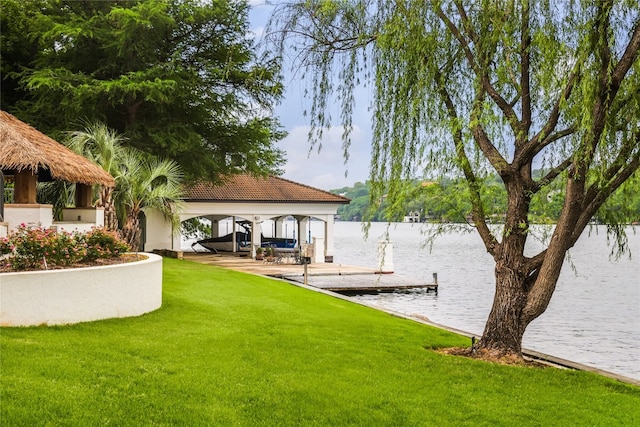 view of dock with a yard, a gazebo, and a water view