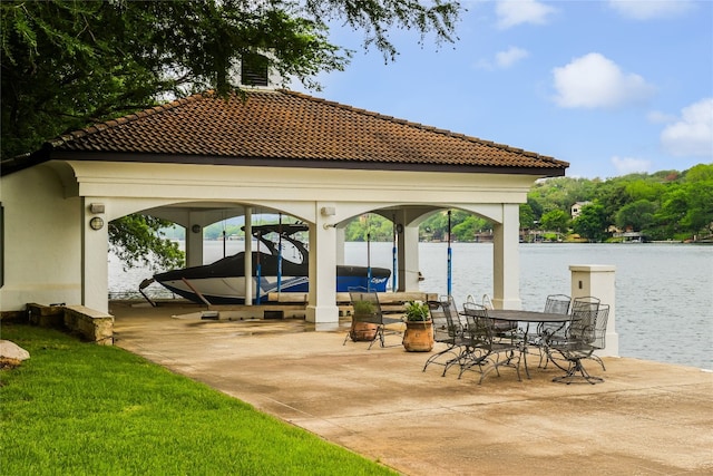 view of patio with a gazebo and a water view