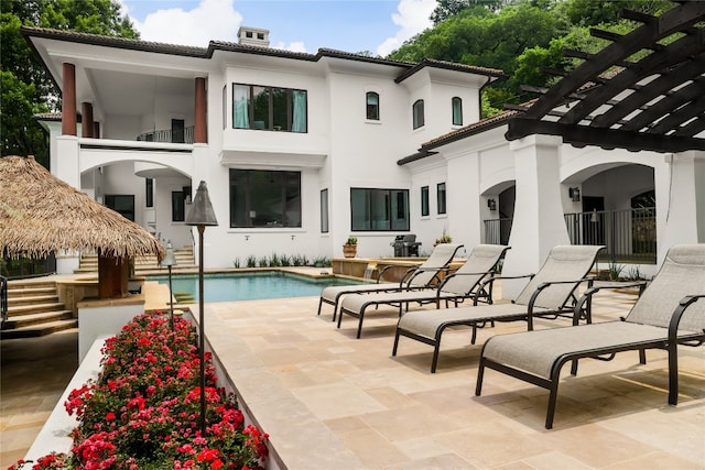 exterior space with a balcony, a pergola, and a patio