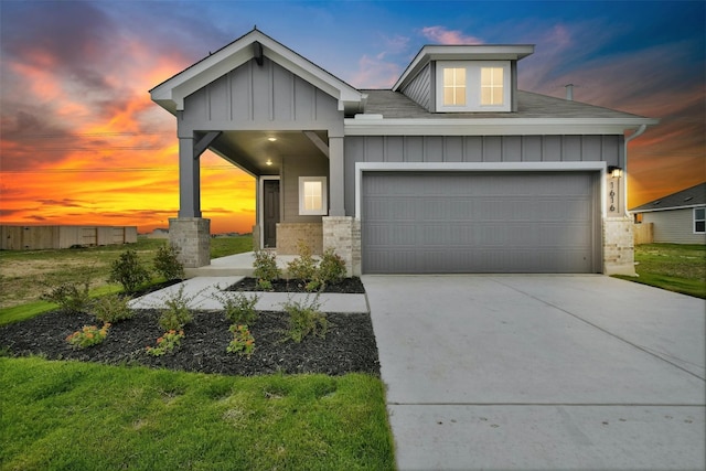 view of front of house with a garage and a lawn