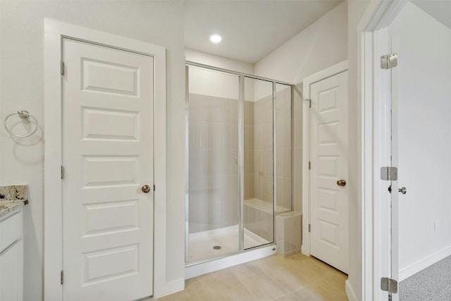 bathroom featuring walk in shower, tile floors, and vanity