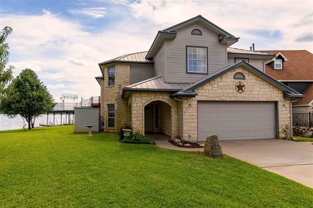 view of front of home with a front lawn and a garage