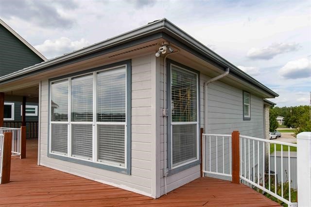 view of property exterior with a deck