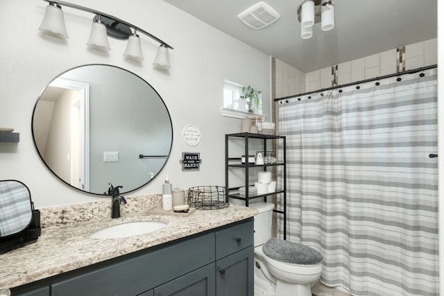 bathroom with toilet and vanity