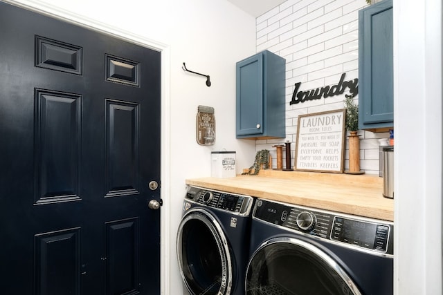 washroom with cabinets and washer and clothes dryer