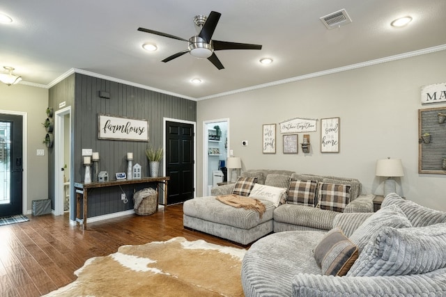 living room featuring ceiling fan, ornamental molding, and dark hardwood / wood-style floors