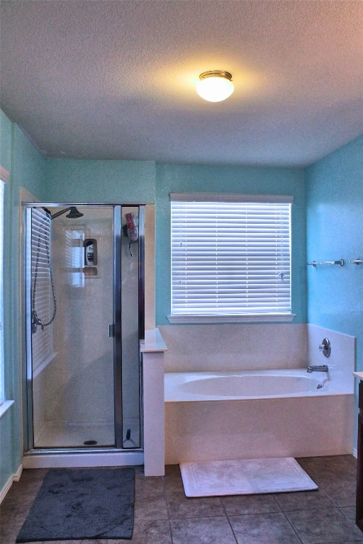 bathroom featuring a textured ceiling, tile floors, and plus walk in shower