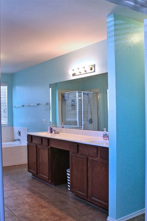 bathroom featuring tile floors, double vanity, and a washtub