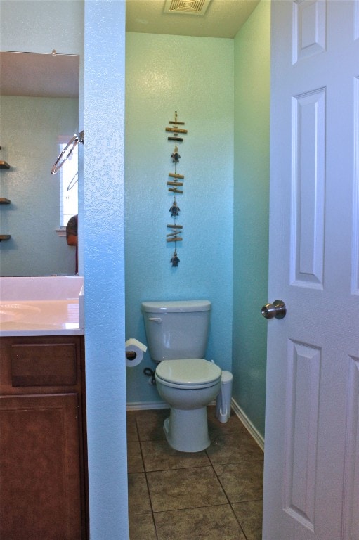 bathroom with vanity, tile floors, and toilet