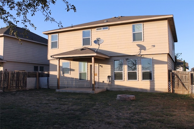 back of house featuring a yard