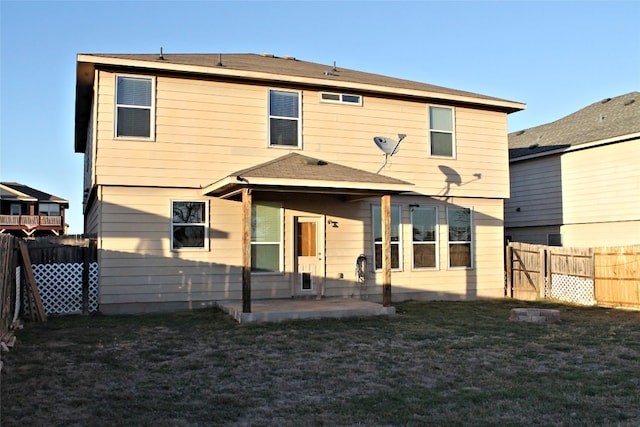 rear view of property with a patio and a yard