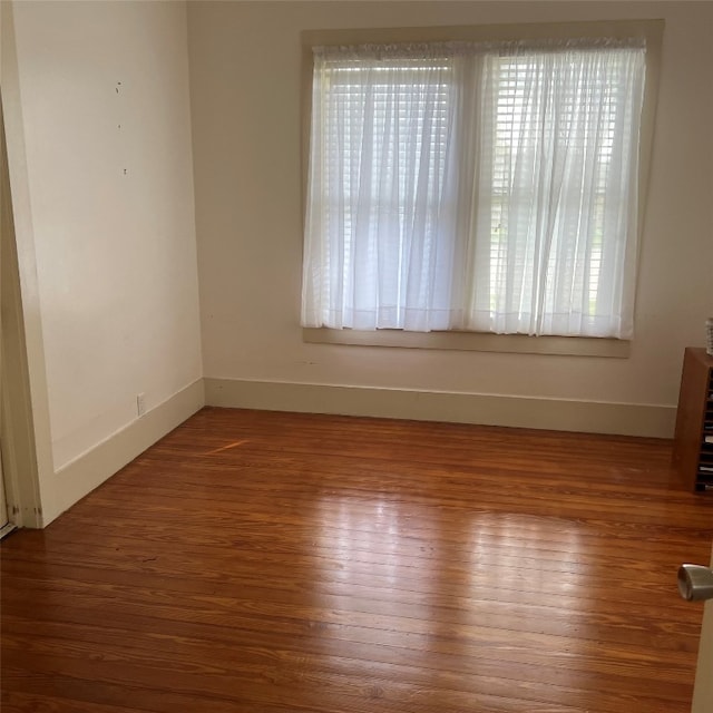 spare room featuring hardwood / wood-style flooring