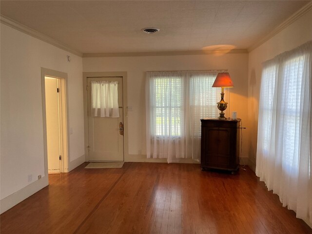 interior space with crown molding and dark wood-type flooring