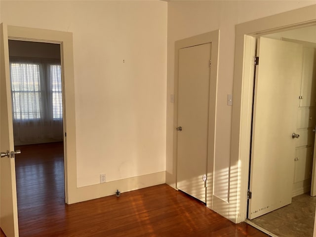 empty room with dark hardwood / wood-style flooring