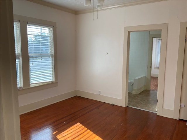 spare room featuring ceiling fan and dark wood-type flooring