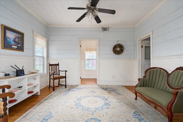 sitting room with crown molding, plenty of natural light, wooden ceiling, and dark hardwood / wood-style flooring