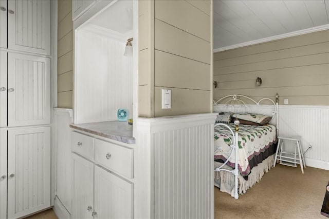 bedroom with crown molding and carpet flooring