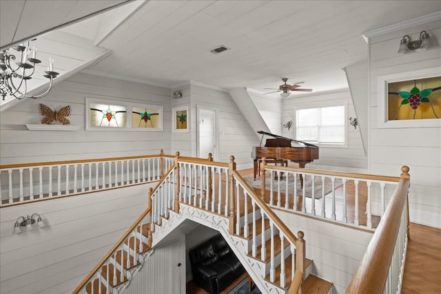 stairs featuring crown molding, wood-type flooring, and ceiling fan