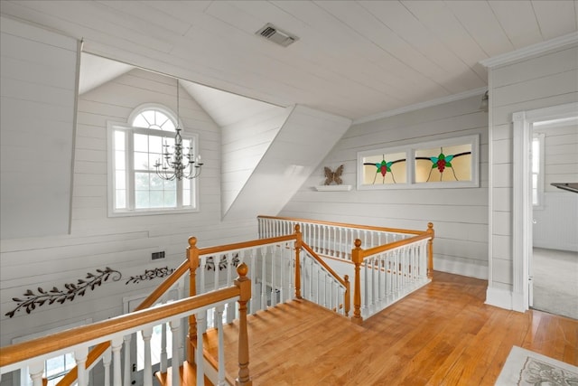 interior space featuring light hardwood / wood-style flooring, vaulted ceiling, and a chandelier