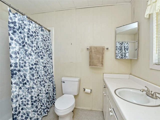 bathroom featuring a shower with curtain, wooden walls, vanity, and toilet