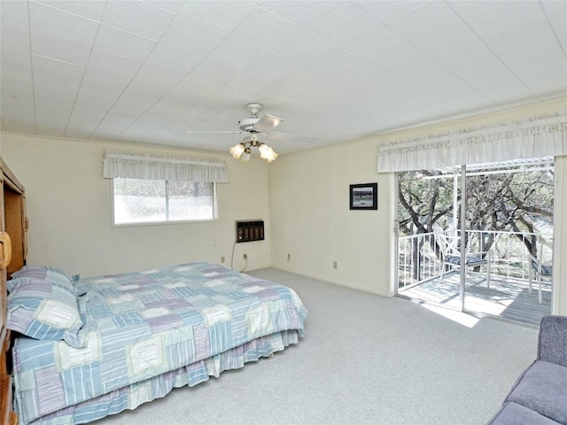 bedroom featuring access to outside, heating unit, ceiling fan, and carpet flooring