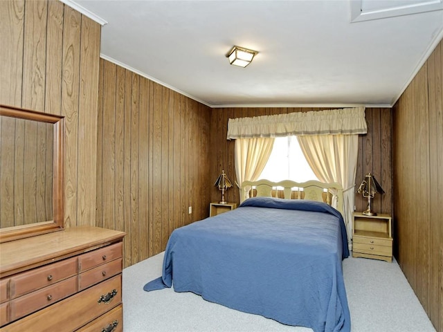 carpeted bedroom with wooden walls and crown molding