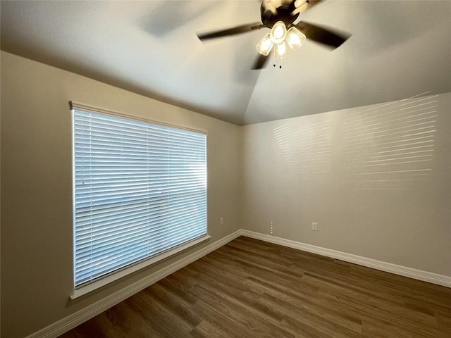 empty room featuring ceiling fan, dark hardwood / wood-style floors, and lofted ceiling